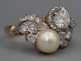 an image of a pearl and diamond ring on a table