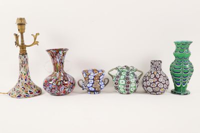 five vases that are sitting next to each other on a table