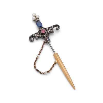 une photo d'une broche avec un manche en bois et une perle