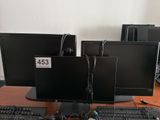 three computer monitors and a keyboard on a desk with a price tag