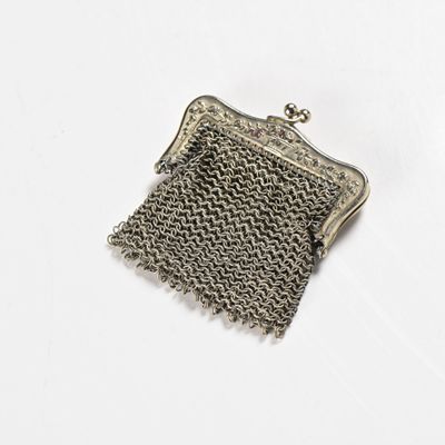 silver metal mesh purse on white background with clipping for clasp