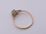a close up of a gold ring with a diamond on it