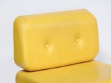yellow leather chair with buttons on the back of it
