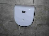 a toilet paper dispenser on the wall in a bathroom