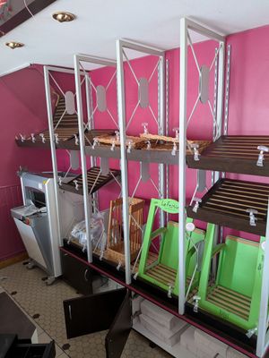 a room with a bunch of shelves that have green bins on them