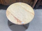 a marble table with a small round top on it