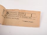 a person holding a piece of paper with a stamp on it