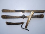 three knives are laying on a white surface with a black handle