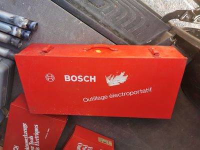 a red box sitting on top of a pile of batteries