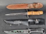three different types of knives and a leather sheath on a table
