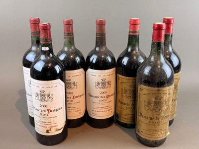 six bottles of wine are lined up in a row on a table