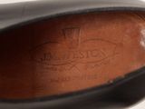 the bottom of a pair of black shoes with a leather sole