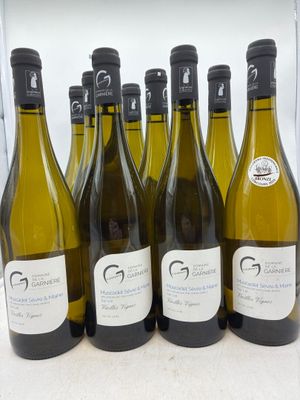 six bouteilles de vin blanc sont alignées sur un comptoir