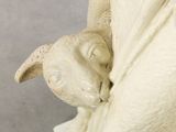 a statue of a dog that is wrapped in a blanket