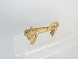 translucent acrylic display case holds a gold colored figurine of a dog