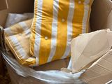 a cardboard box with a pillow and a pillow in it