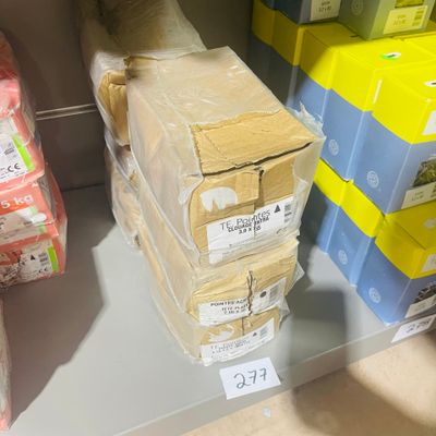 boxes of toilet paper are stacked on top of each other on a shelf