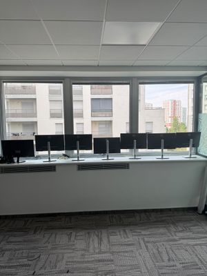 a picture of a room with a lot of computers on the desks