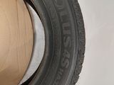 a close up of a tire on a white surface