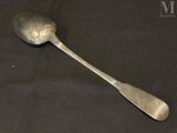 a spoon and a spoon rest on a black cloth