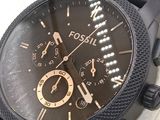 a close up of a black watch on a white surface