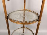 an antique brass and glass three tiered display stand