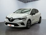 Une voiture blanche est garée dans un garage au sol noir.