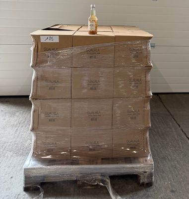 boxes stacked on a pallet with a bottle of beer on top