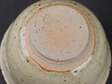 a close up of a vase on a black surface
