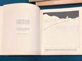 an open book with a picture of a mountain in the background