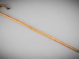 an old wooden walking stick with a black handle on a gray background