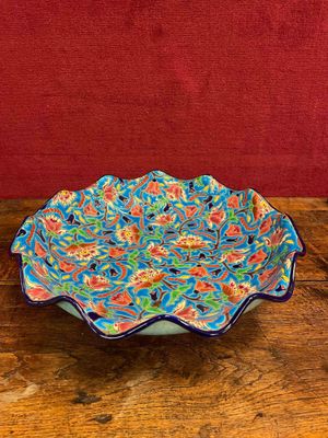 a picture of a colorful bowl on a wooden table