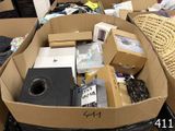 une boîte remplie d'appareils électroniques et d'autres objets dans une pièce