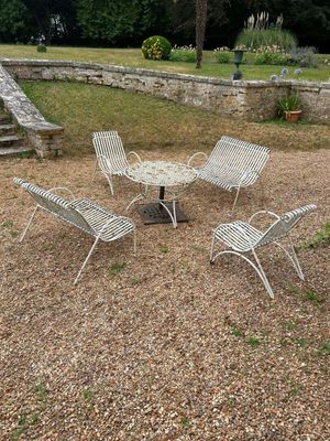 une table et des chaises au milieu d'une aire en gravier