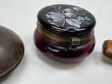 a small box with a lid sitting next to a small wooden object