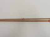 a pair of wooden cues with a red string on top of them