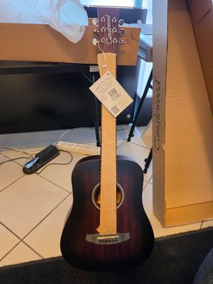 a guitar that is sitting on the floor in front of a box