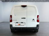 the rear end of a white van parked in a garage