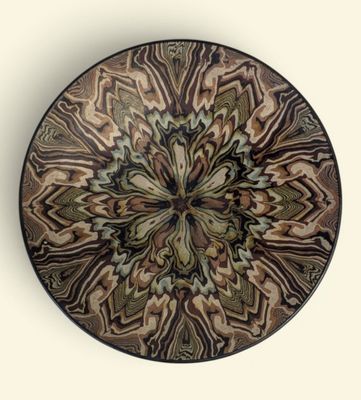 a brown and black plate with a pattern on it