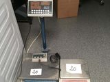 a scale that is sitting on the floor next to some boxes