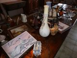 une table sur laquelle sont posés de nombreux vases et autres objets