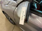 a close up of a car door handle with a sticker on it