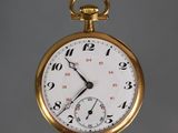 a close up of a gold pocket watch with numbers on it
