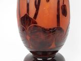 a glass vase with a design on it on a stand