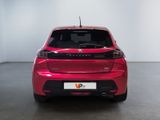 the rear end of a red car in a white room