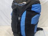 a black and blue backpack sitting on a white surface
