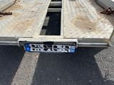 a flat bed trailer with a flat bed attached to it