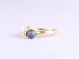 a close up of a gold ring with a blue stone