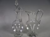 two glass vases sitting next to each other on a table