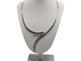 necklace with a snake on a mannequin stand on a white background